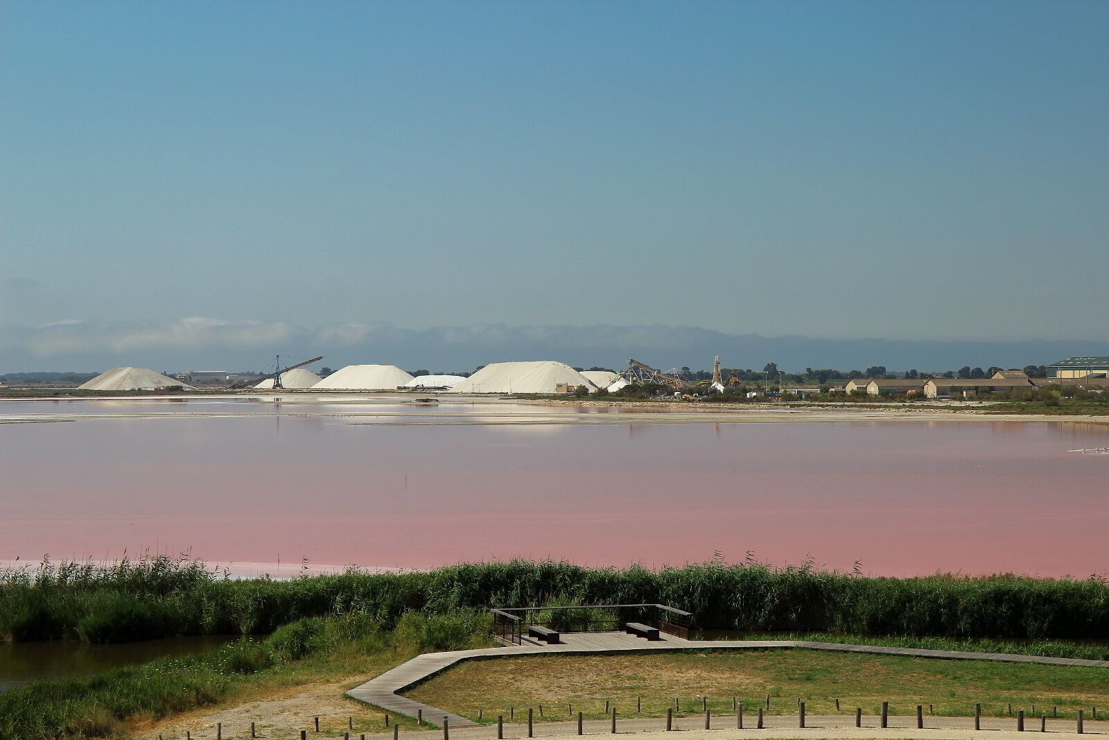 A large body of water with industrial structures in the background.