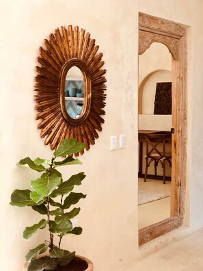 A room with a large mirror, a potted plant, and a doorway leading to another room. - Bella Verde, Steps to beach, shops and restaurants (San Francisco)