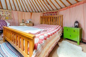 A room with a wooden bed, a green dresser, and a pink curtain. - 1 Bed in Blackborough (oc-w42630) (Blackborough)