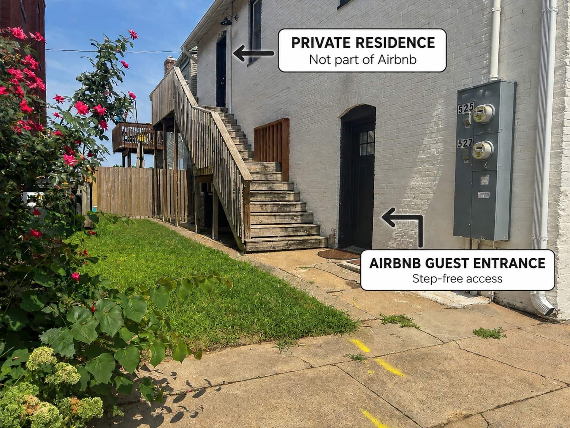 A private residence with a step-free guest entrance and a staircase leading to a wooden deck.