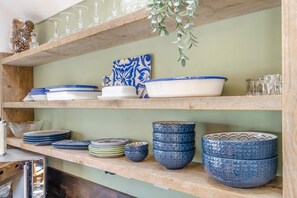 A kitchen shelf with various ceramic dishes and glassware. - 2 Bed in Partney (oc-v44757) (Partney)