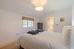 A bedroom with a bed, a window with a view, a wardrobe, and a door leading to a bathroom. - 6 Bed in Herons Ghyll (oc-t44940) (Heron's Ghyll)