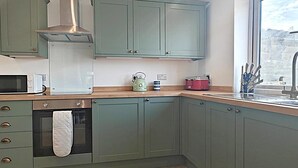 A kitchen with a microwave, kettle, toaster, and oven. - 3 Bed in Pendeen (oc-g33305) (Pendeen)