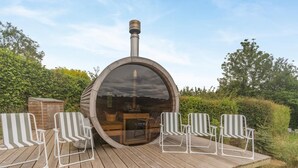 A wooden deck with a circular structure, possibly a sauna, and four striped chairs. - 2 Bed in Overton (oc-k45280) (Overton)