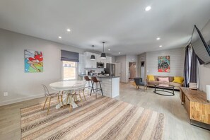 A modern interior with a dining area, kitchen, and living space.