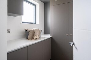 A modern bathroom with a window, a towel, and a door. - 2 Bed in Bude (oc-b588790) (Bude)