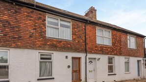 A two-story residential building with a brick facade, white-painted lower walls, and a visible chimney. - 2 Bed in Rye (oc-s43273) (Rye Harbour)