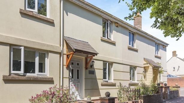 A two-story residential building with a flat roof, a front door, and a small porch area. - 3 Bed in Bridport (oc-b45261) (Bridport)