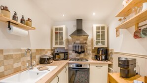 A compact kitchen with a sink, stove, microwave, and various utensils. - 1 Bed in Dunblane (oc-j36313) (Bannockburn)