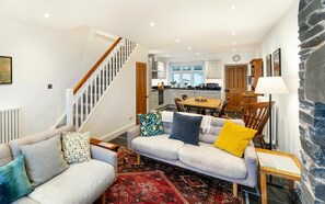 A living room with a sofa, a coffee table, and a patterned rug. - 3 Bed in Coniston (oc-lr149) (Coniston)