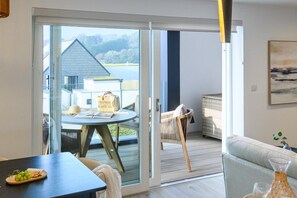 Ein modernes Interieur mit einer Schiebeglastür, die auf eine Terrassenfläche führt.