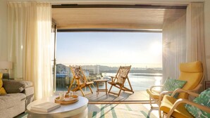 A room with a sofa, two rocking chairs, a small table, and a view of a body of water. - 3 Bed in Hayle (oc-b635644) (Hele)