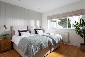 A bedroom with a double bed, bedside tables, a radiator, a window with a view, and a potted plant. - 4 Bed in Charlestown (oc-b610558) (Charlestown)