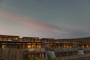 A modern hotel with multiple levels and balconies, featuring a contemporary architectural design. - 4 Bed in Watergate Bay (oc-b584373) (Tregurrian)