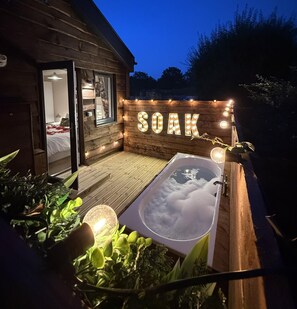 A wooden cabin with a spa area, including a hot tub and a sign that reads 'SOAK'. - 2 Bed in Wichenford (oc-t45441) (Ockeridge)
