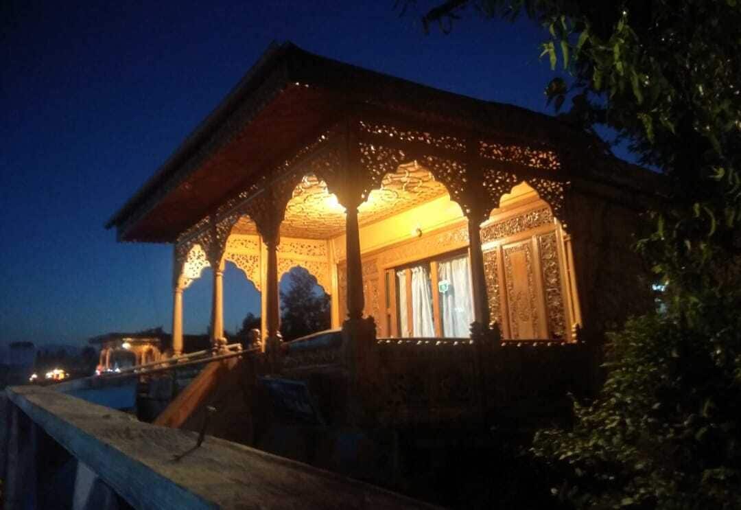 A traditional building with ornate architectural details and a covered porch.