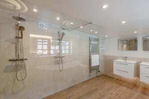 A modern bathroom with a glass shower enclosure, a vanity with a mirror, and a towel rack. - 5 Bed in Bishops Lydeard (oc-b45427) (Triscombe)