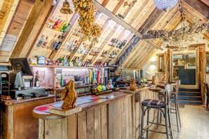 A rustic bar area with wooden beams, a cash register, and various bottles. - 5 Bed in Bishops Lydeard (oc-b45427) (Triscombe)