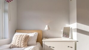 A bedroom with a bed, a nightstand, a lamp, and a picture frame. - 2 Bed in Ambleside (oc-lr114) (Chapel Stile)