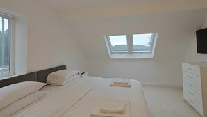 A bedroom with a bed, a dresser, a window, and a TV. - 5 Bed in Llandderfel (oc-b45562) (Llandderfel)