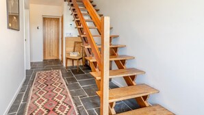 A wooden staircase with a handrail leading to a landing. - 3 Bed in Llwyn Du (oc-t44969) (Abergavenny)