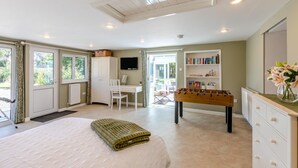 A bedroom with a bed, a desk, a foosball table, a bookshelf, and a TV. - 1 Bed in Combe (oc-g45502) (Combe)
