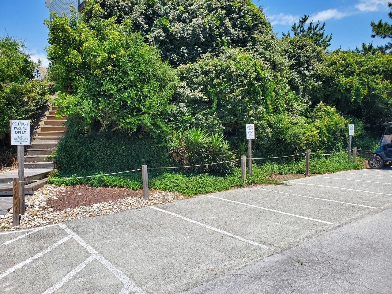 A parking area with a sign indicating it is for golf carts only.