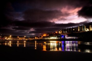 A waterfront town at night with buildings reflecting on the water, a bridge, and a cloudy sky. - 4 Bed in Bolingey (oc-m45595) (Bolingey)