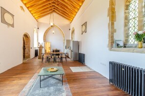 A spacious room with a wooden floor, a dining table, and a kitchen area. - 2 Bed in Market Stainton (oc-s45536) (Market Stainton)