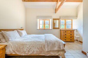 A bedroom with a bed, dresser, mirror, and two windows with shutters. - 2 Bed in Awre (oc-o45277) (Awre)