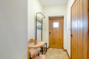 A narrow hallway with a wooden door, a coat rack, and a small table with chairs. - 2 Bed in Awre (oc-o45277) (Awre)
