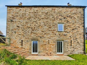 A stone building with two doors and a small window. - 3 Bed in Slaggyford (oc-h44976) (Slaggyford)