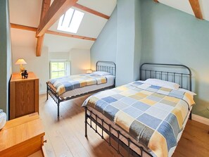 A bedroom with two metal bunk beds, a wooden nightstand, a lamp, and a window with natural light. - 3 Bed in Slaggyford (oc-h44976) (Slaggyford)