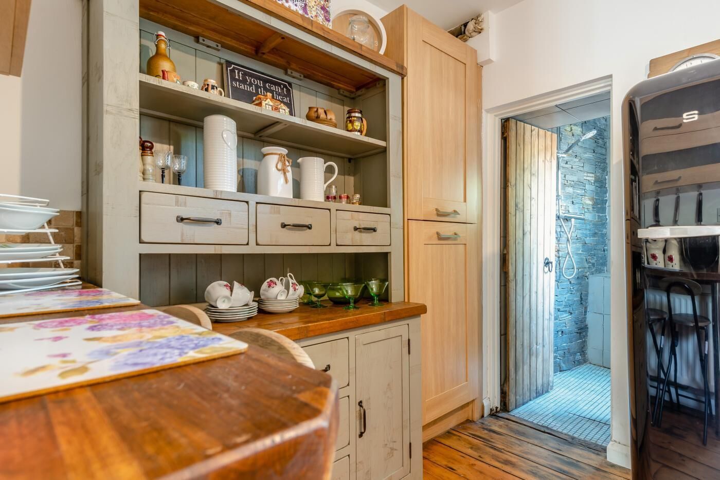 A kitchen with wooden cabinets, a countertop, and various kitchenware.