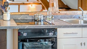 A kitchen with a built-in oven, a sink, and a countertop with various kitchen utensils. - 2 Bed in Cradley (oc-s45721) (Cradley and Storridge)