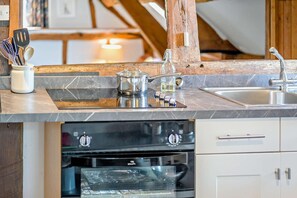 A kitchen with a built-in oven, a sink, and a countertop with various kitchen utensils. - 2 Bed in Cradley (oc-s45721) (Cradley and Storridge)