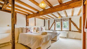 A bedroom with a wooden ceiling, two beds, a window, and a radiator. - 2 Bed in Cradley (oc-s45721) (Cradley and Storridge)