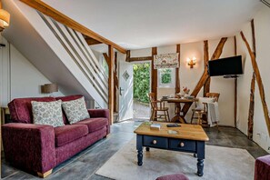 A furnished living room with a sofa, coffee table, and a dining area with chairs and a table. - 1 Bed in Cradley (oc-w45725) (Cradley and Storridge)