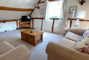 A cozy living room with a wooden coffee table, beige sofa, and a television on a wooden stand. - 2 Bed in Cradley (oc-h45727) (Cradley and Storridge)