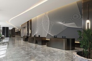A modern reception area with a patterned wall, a curved ceiling, and a marble floor.