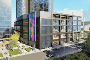 A modern building with multiple floors, large windows, and a central atrium. - JW Marriott Detroit Water Square (Detroit)