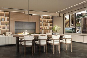 A modern dining area with a central fire feature, wooden panel walls, and a large flat-screen TV. - Fairfield By Marriott Xi'An Weiyang (Xi'an)