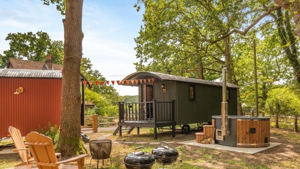 A rustic outdoor setting with a wooden deck, a small cabin, and a hot tub. - 1 Bed in Shipley (oc-s34110) (Shipley)
