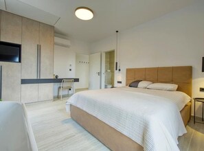 A modern bedroom with a large bed, a desk, and a TV. - Two Bedroom Villa with Swimming Pool (Jastrebarsko)