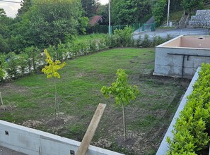 A landscaped garden area with young trees and a concrete structure. - Two Bedroom Villa with Swimming Pool (Jastrebarsko)