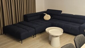 A sectional sofa with a round coffee table and a side table. - Two Bedroom Villa with Swimming Pool (Jastrebarsko)