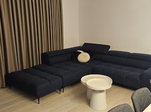A sectional sofa with a round coffee table and a side table. - Two Bedroom Villa with Swimming Pool (Jastrebarsko)
