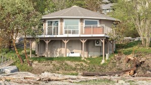 A two-story house with a balcony, garage, and a small porch area. - WM BLOCK Deer Harbor 1br (Deer Harbor)