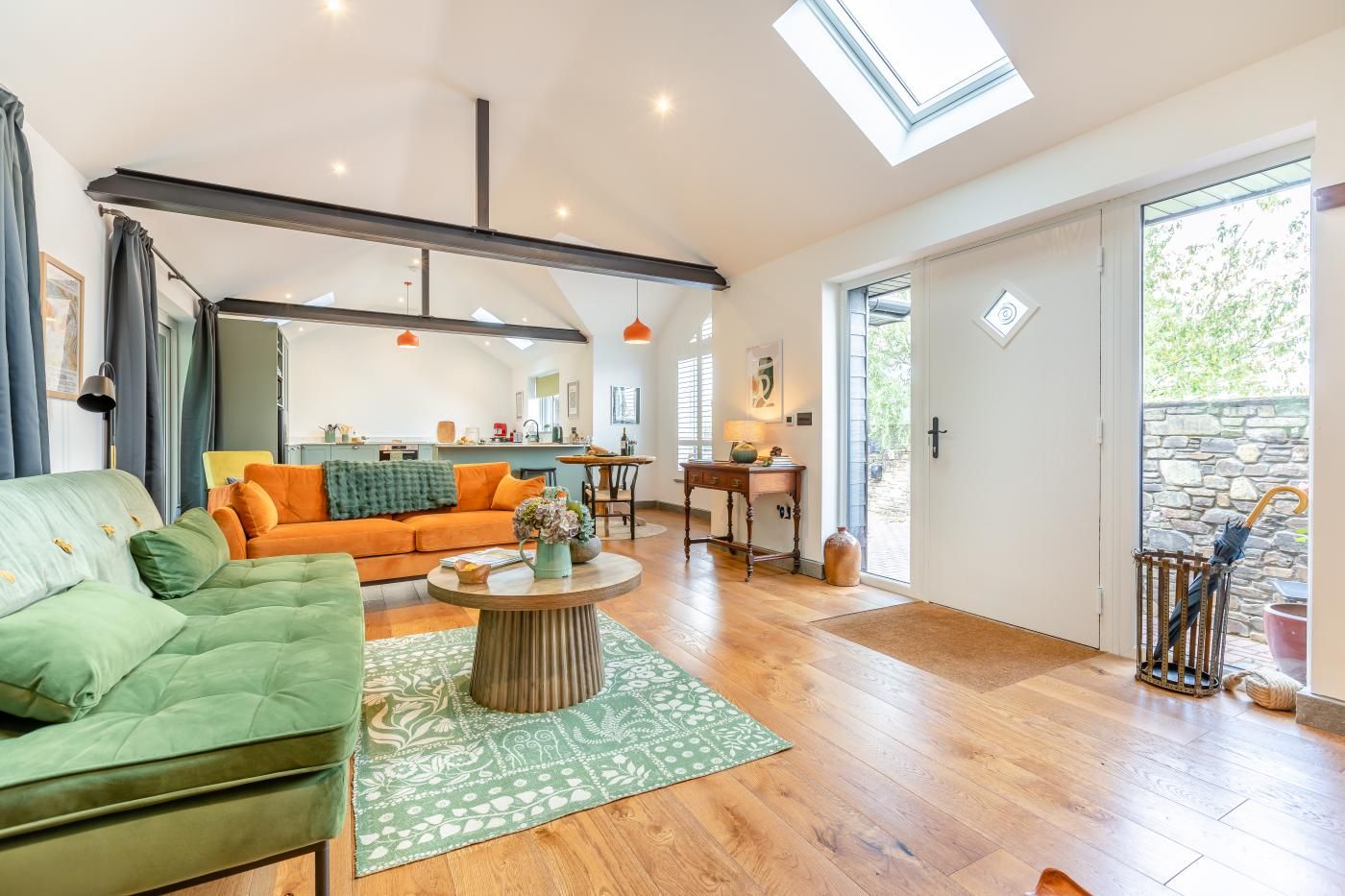 A spacious living room with a sofa, a coffee table, and a dining area.
