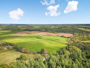 A rural landscape with fields, trees, and a few buildings. - 1 Bed in Eggesford (oc-l45452) (Wembworthy)